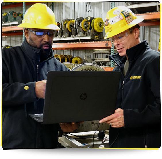 Photo of workers looking at a laptop